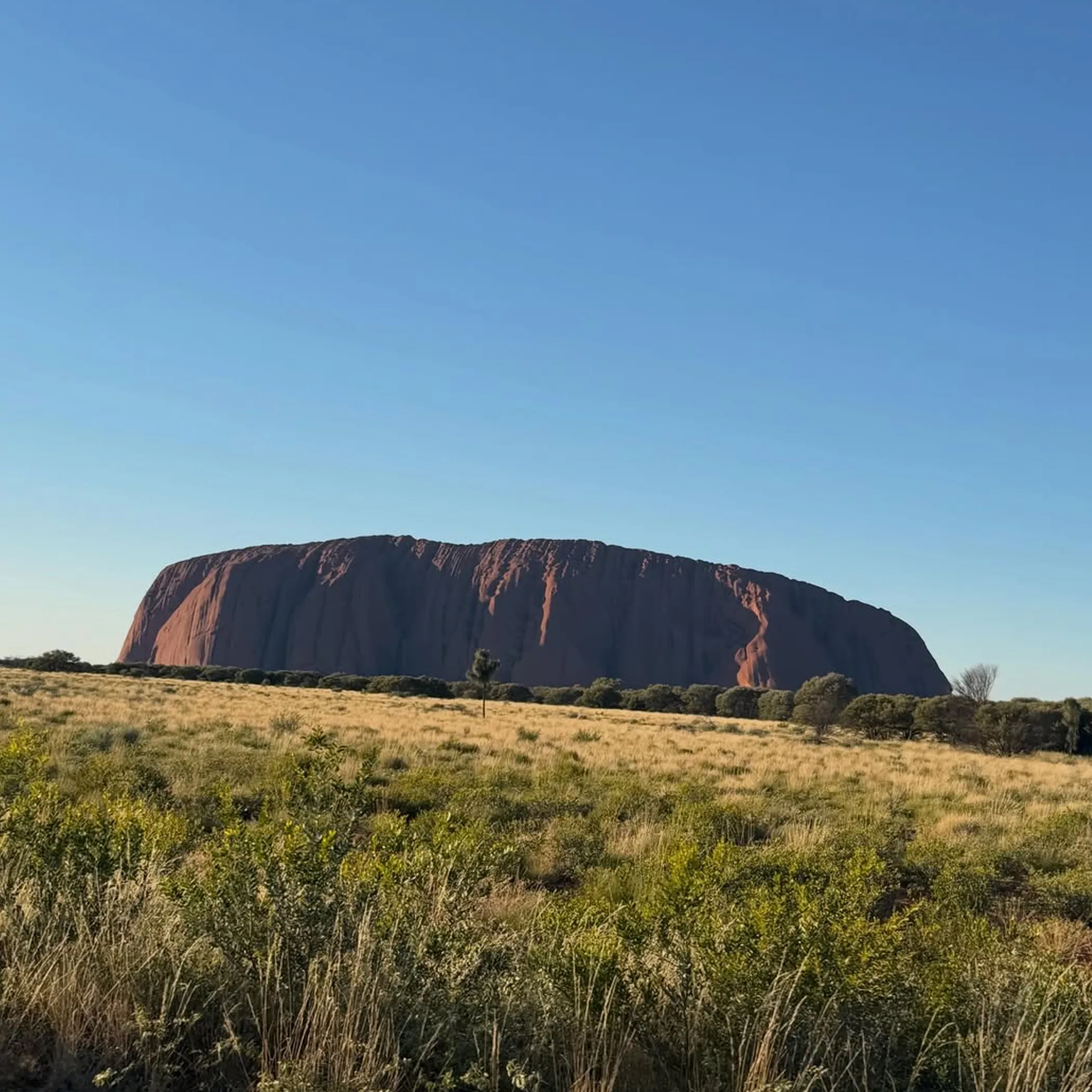 uluru rock formation with clear sky